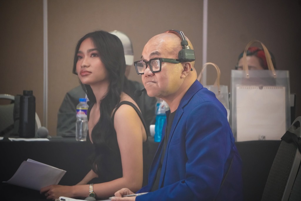 Event officials observing the program